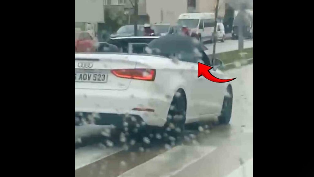 Milyonluk arabada ıslanmamak için bulduğu yöntem görenleri şaşkına çevirdi
